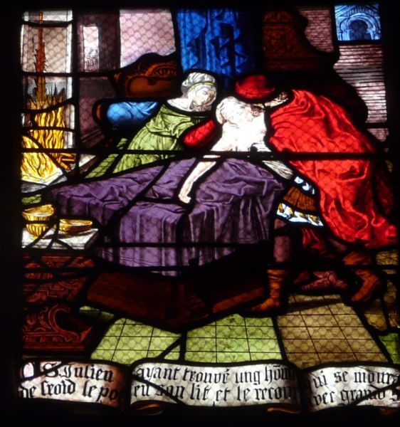 Julianus en zijn vrouw leggen een doodzieke man in hun eigen bed (Hij blijkt later zich bekend te maken als Christus zelf!).