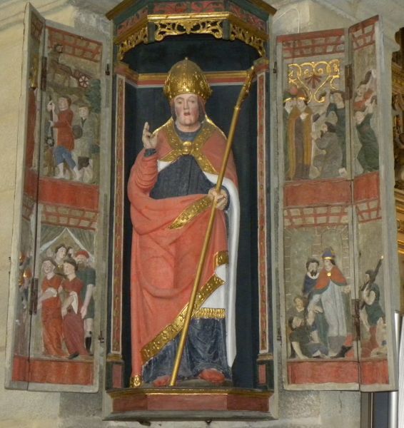 St Thégonnec met scènes uit zijn leven. rechts.boven: verkondigt met Pol Aurélien + vrouwen doen boete (trekken hun haren uit), rechts beneden: geneest zieken, links boven: ossenkar en hert helpen bij bouw kerk, links beneden: feestelijke inwijding nieuwe kerk (bisschoppen en dansende vrouwen).