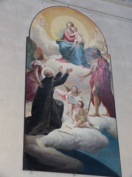 Johannes Leonardi begroet Maria met Kind in de hemel en vraagt in de hemel te worden opgenomen. Zijn bede wordt versterkt door de voorspraak van zijn patroon Johannes de Doper die wijst naar een engeltje dat zijn regel vasthoudt voor de door hem gestichte religieuze congregatie en door een engel die hem met zachte hand bij Maria aanbeveelt. Eind 19e eeuw, wandschildering