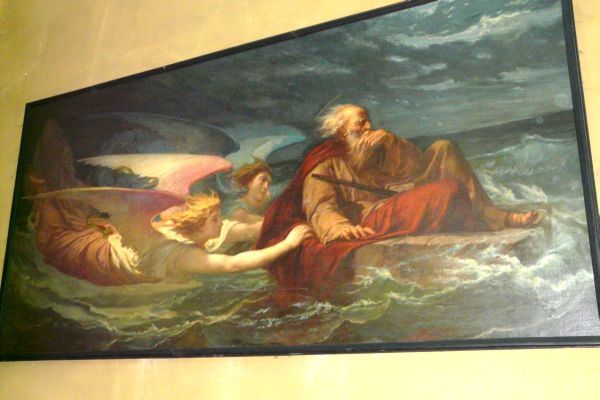 Sint Houardon op grote steen door engelen over zee geduwd.